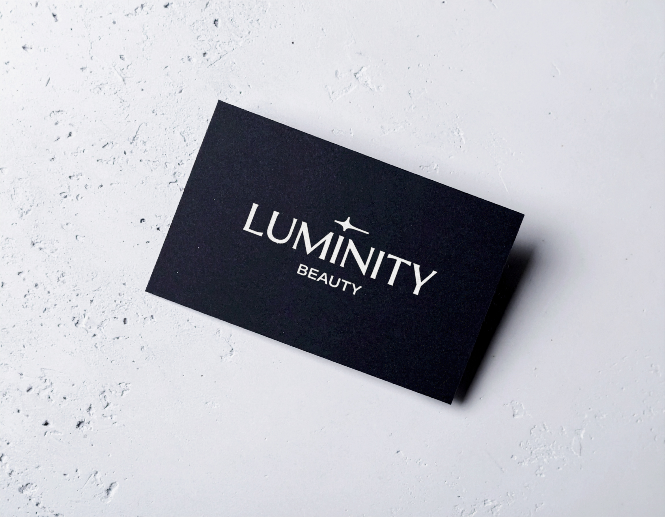 Luminity Beauty black business card with white custom logotype